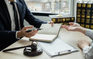 A male lawyer or judge counseling clients about judicial justice and prosecution, with scales of justice, a judge's gavel, and legal documents, embodying the concept of legal services.