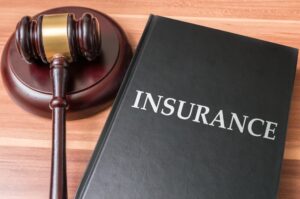 Insurance Book with Judge's Gavel