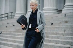 serious businesswoman hurrying with documents from courthouse